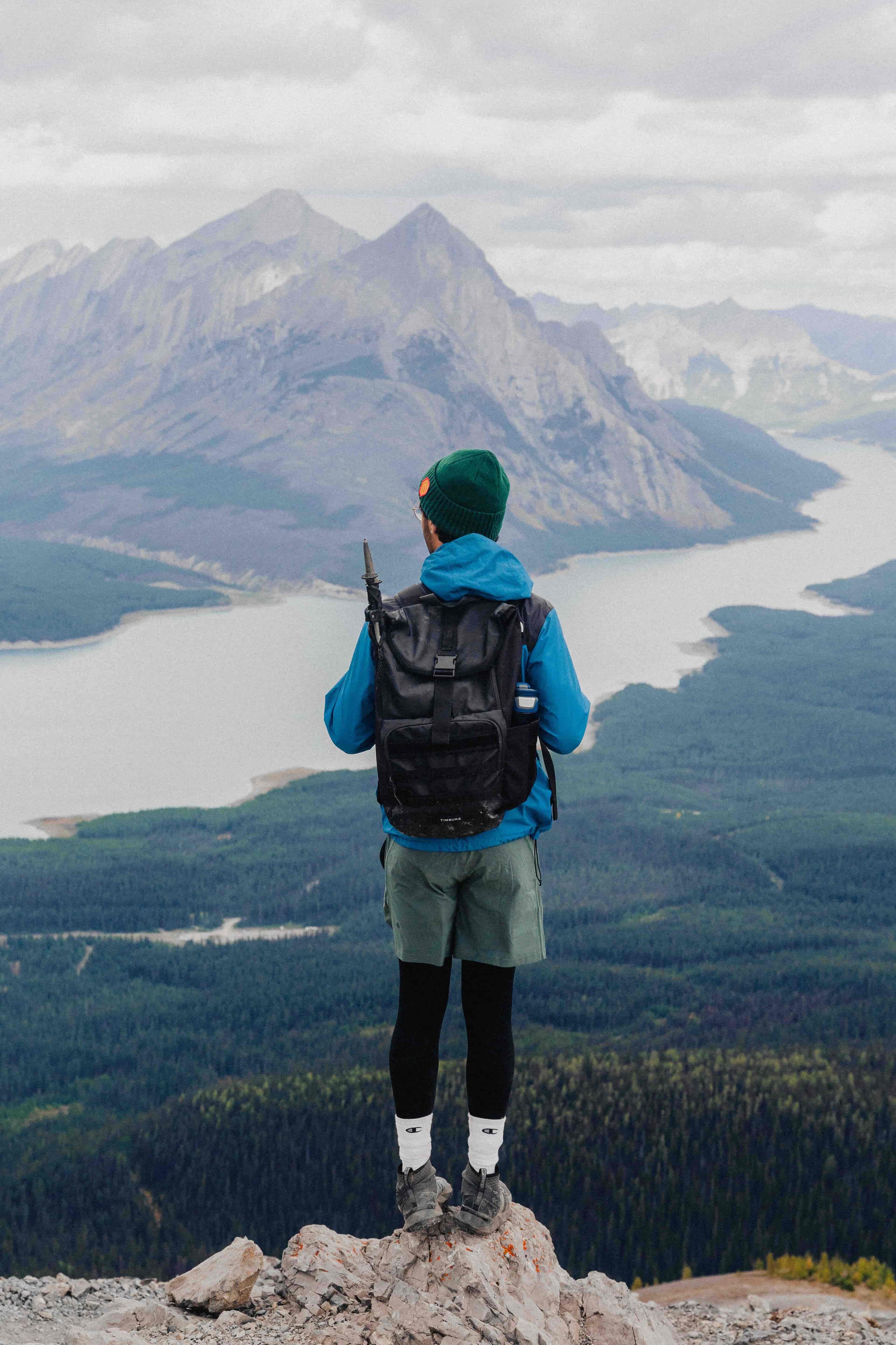 Photo of myself standing in front of a lake and mountain peak